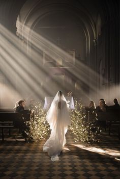 a bride and groom walking down the aisle