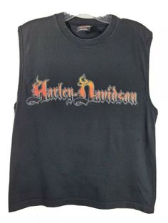 a black harley davidson shirt with the words harley davidson written in orange and red on it