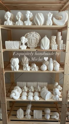 the shelves are filled with different types of vases and other decorative items in white