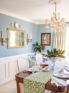 the dining room table is set with place settings