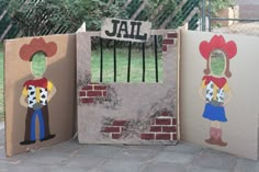 three cardboard boxes with pictures of children's characters painted on them, one in the shape of a jail cell