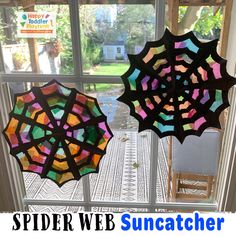 two stained glass umbrellas sitting on top of a window sill