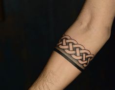 a man's arm with a tattoo on it that has an intertwined design