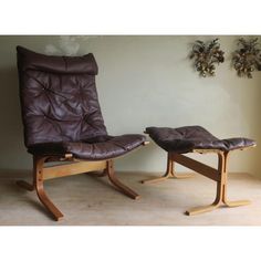 two brown leather chairs sitting next to each other