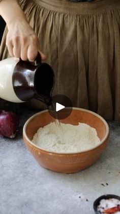 a person pouring batter into a bowl