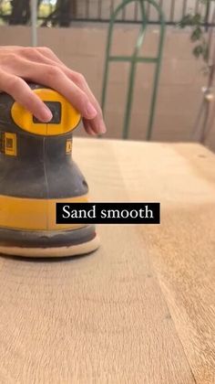 a sander being used on a table with the words sand smooth