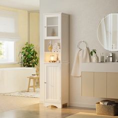 a bathroom with a sink, mirror and bathtub next to a potted plant