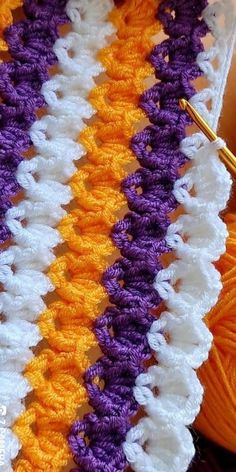 an orange, white and purple crochet scarf