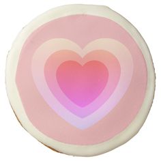 a pink and white cookie with a heart on it