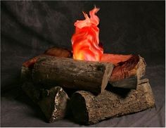 a lit candle sitting on top of logs