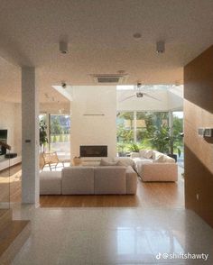 an open living room with white furniture and large windows