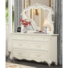 a white dresser and mirror in a room