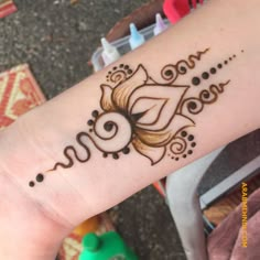 a woman's arm with a henna tattoo on it