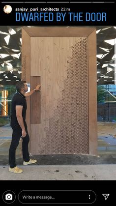 a man standing in front of a wooden door with the words, carved by the door written on it