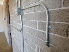 a brick wall with metal bars attached to it