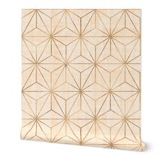 a white and gold wallpaper with an intricate geometric design on it's side