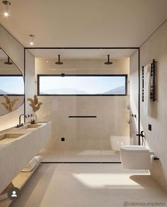 a modern bathroom with two sinks and large mirrors on the wall, along with a walk in shower