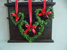 two heart shaped wreaths hanging on a wall