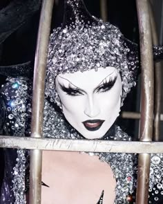 a close up of a mannequin in a cage with lots of glitter on it