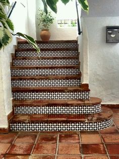 the stairs are decorated with black and white tiles