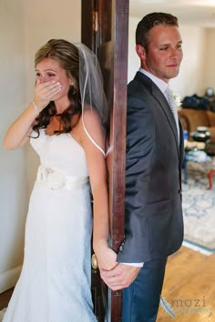 a man and woman standing next to each other in front of a mirror with the caption's name on it