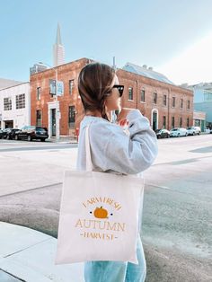 This cotton canvas bag is a versatile and durable accessory, perfect for everyday use. It’s ideal for carrying groceries, books, and other daily essentials. The sturdy canvas ensures longevity, allowing the bag to withstand years of regular use. Plus, being reusable and eco-friendly, it's a great alternative to single-use plastic bags, helping reduce waste and environmental impact. The handles, crafted from the same durable fabric, offer comfort and ease, even when carrying heavier loads, making it as practical as it is sustainable.
100% cotton canvas
Heavyweight fabric (12 oz/yd², 406.9 g/m²)
Sewn-in label for added quality"
15’’ x 16’’ inch 
20’’ inch handles 
-PLEASE NOTE-
Colors in the mockups may appear slightly different from the final product. 
-SHIPPING-
We offer FREE SHIPPING. Est Autumn Accessories, Fall Tote Bag, Fall Tote, Eco Friendly Bags, Autumn Harvest, Fall Accessories, Reduce Waste, Seasonal Gifts, Plastic Bags