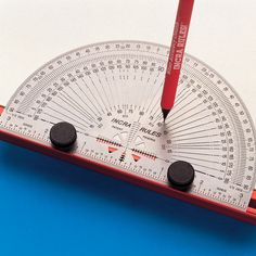 a red and white protractor sitting on top of a blue surface