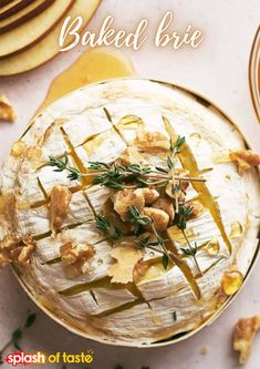 baked brie with apples and walnuts on a white plate next to other dishes