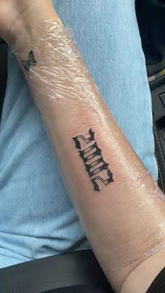 a person's arm with a tattoo on it and the word faith written in black ink