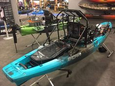 a blue kayak is on display in a showroom