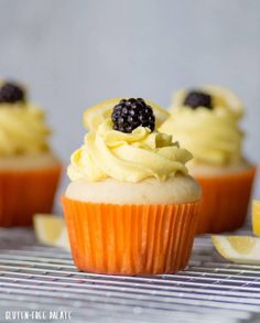 cupcakes with lemon frosting and blackberries on top