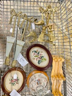 there are many different types of decorative items on the wire rack in this room, including plates and vases