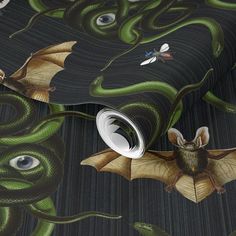 a wallpaper with an image of a bat and two dragon eyes on it's side