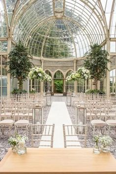 the inside of a building with rows of chairs and tables set up for an outdoor ceremony