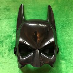 a batman mask is shown on a green background