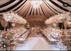 an image of a wedding venue with flowers and chandeliers on the ceiling,