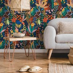 A cozy living room corner with a gray sofa, a wooden side table with copper legs, and a Heart of the Jungle Wallpaper Mural by Decor2Go Wallpaper Mural. A pair of slippers rests on the wooden floor beside a woven basket. Jungle Mural, Jungle Wallpaper, How To Install Wallpaper, Decoration Piece, Wallpaper Mural, Rich Colors, Tropical Paradise, Metallic Colors, Feature Wall