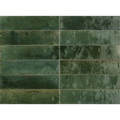 a green tile wall that has been painted in different shades and sizes, with the same color