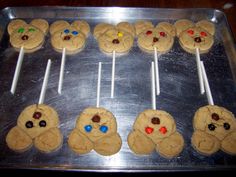 there are many cookies and marshmallows on the cookie sheet with toothpicks