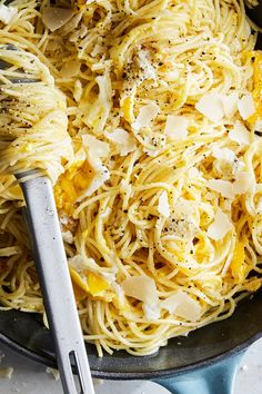 a skillet filled with spaghetti and cheese