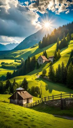 the sun shines brightly over a green hillside with houses and mountains in the background