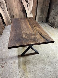 a wooden table sitting on top of a cement floor