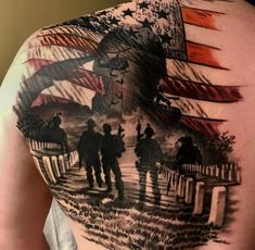 the back of a man's shoulder with an american flag and soldiers on it