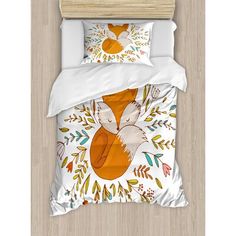 a bed with an orange fox and leaves on it