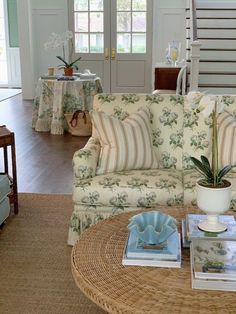 a living room filled with furniture and a coffee table in front of a doorway that leads to another room