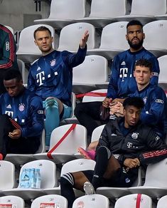 several soccer players are sitting in the stands and one man is holding a water bottle