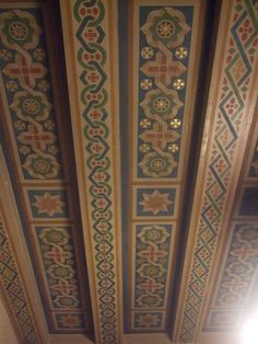 the ceiling is decorated with intricate designs and colors, including blue, green, yellow and red