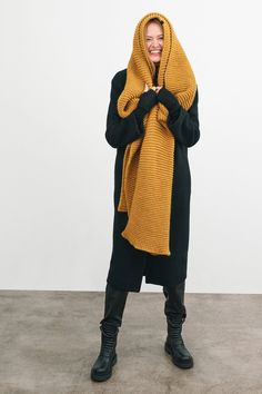 Make your style A LOT cozier with our extra-long Bronx Scarf. Bronx is both knit from ultra-soft French Merino Wool mix to warm your soul and fashioned extra long to make a statement. Wrap this Merino wool scarf around and around for volume, or wear her draped over your shoulders to lend your look texture and drama. This soft wool scarf also doubles perfectly as an airplane blanket. | Emmy, in burnt yellow, is 5'10.5" (179 cm), wearing size XS. Natalee, in medium grey, is 5'10" (178 cm) tall. As Wide Crochet Scarf, Knit Scarf Outfit, Burnt Yellow, Airplane Blanket, Super Scarf, Chunky Infinity Scarves, Big Scarf, Big Knits, Merino Wool Scarf