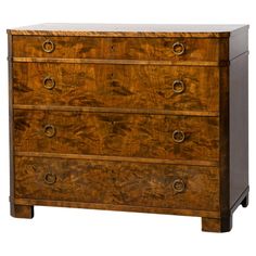 an antique chest of drawers with brass hardware and wood grained finish on the top