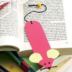 an open book with a paper mouse on it